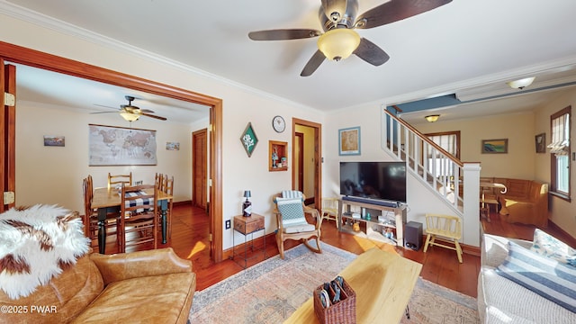 living room with ceiling fan, wood-type flooring, and crown molding