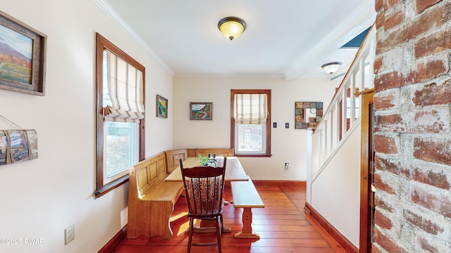 dining room with hardwood / wood-style flooring, breakfast area, and crown molding