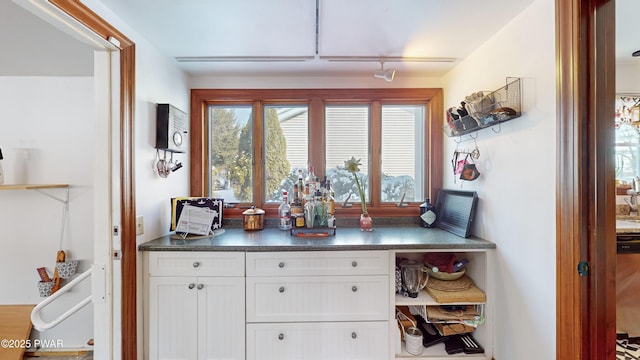 kitchen featuring white cabinets and track lighting