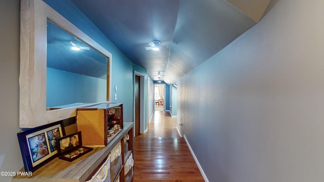 hallway featuring hardwood / wood-style floors and lofted ceiling