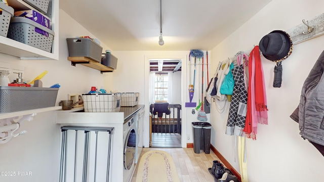 laundry area with rail lighting and washer and clothes dryer