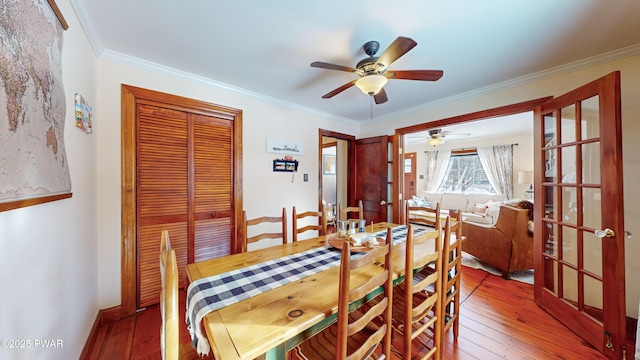 dining area with ceiling fan, wood-type flooring, and crown molding