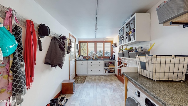 washroom with light hardwood / wood-style floors and washer / clothes dryer