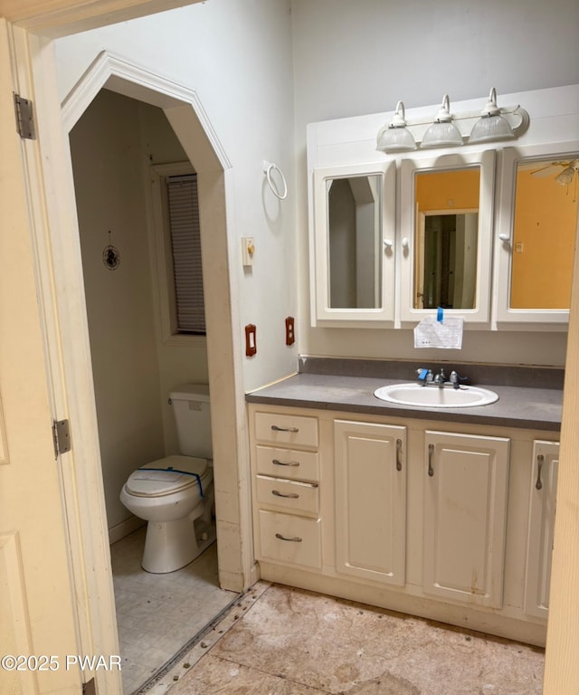 bathroom featuring vanity and toilet
