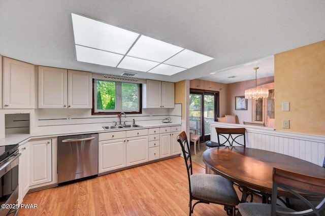 1528 Mount Cobb Rd, Jefferson Township, PA 18436 - kitchen with appliances with stainless steel finishes, light countertops, light wood-type flooring, a chandelier, and hanging light fixtures