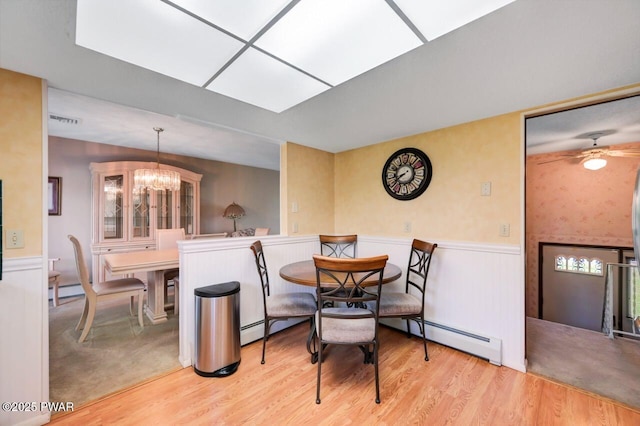 1528 Mount Cobb Rd, Jefferson Township, PA 18436 - dining area featuring baseboard heating, wainscoting, wood finished floors, and a chandelier