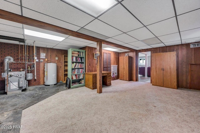1528 Mount Cobb Rd, Jefferson Township, PA 18436 - below grade area featuring wooden walls, a paneled ceiling, electric water heater, a wood stove, and a heating unit