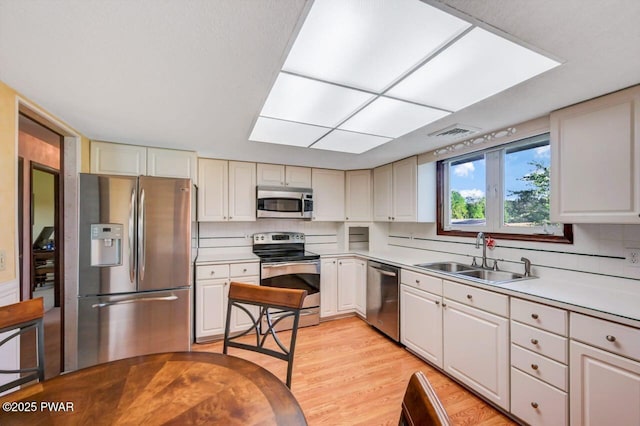 1528 Mount Cobb Rd, Jefferson Township, PA 18436 - kitchen featuring appliances with stainless steel finishes, tasteful backsplash, light countertops, and light wood-style flooring