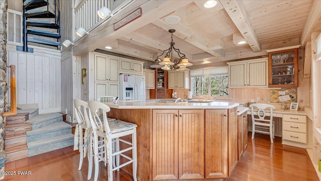 kitchen featuring light countertops, wooden ceiling, white refrigerator with ice dispenser, and light wood-type flooring
