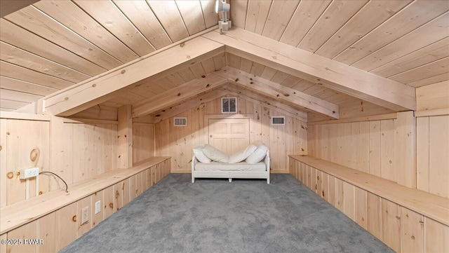 unfurnished room featuring carpet floors, lofted ceiling with beams, wood walls, and wooden ceiling