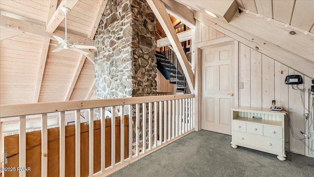 interior space with vaulted ceiling with beams, wood ceiling, and carpet floors