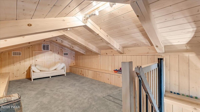 interior space featuring vaulted ceiling with beams, wooden walls, wooden ceiling, and visible vents