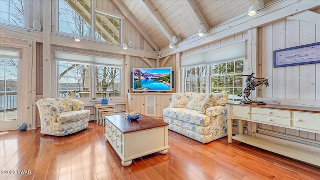 sunroom featuring beam ceiling