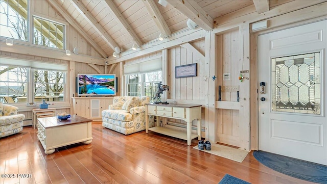 sunroom featuring a baseboard radiator and beam ceiling