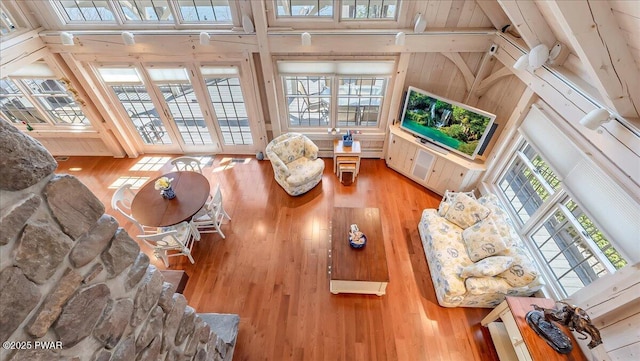 living area featuring high vaulted ceiling and hardwood / wood-style flooring