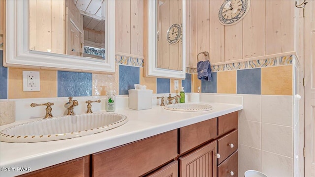 full bathroom with double vanity and a sink