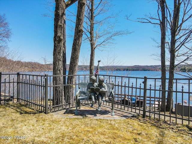 view of yard featuring fence and a water view