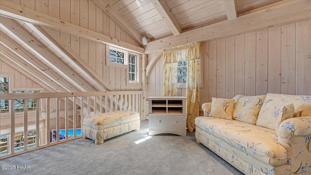 interior space with vaulted ceiling with beams, carpet flooring, wooden walls, and a healthy amount of sunlight