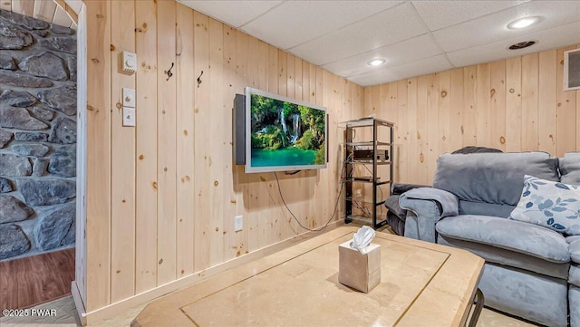 living room with recessed lighting, wood walls, and a paneled ceiling