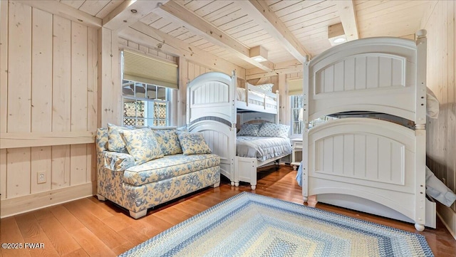 bedroom with wood walls, wood ceiling, and wood finished floors