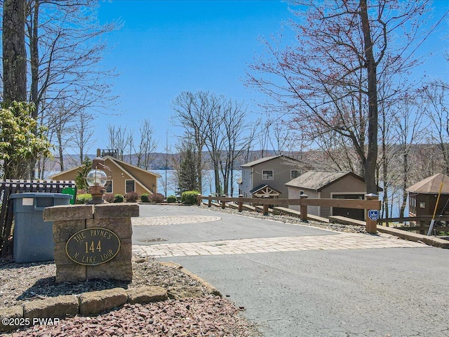 view of road with a residential view and driveway