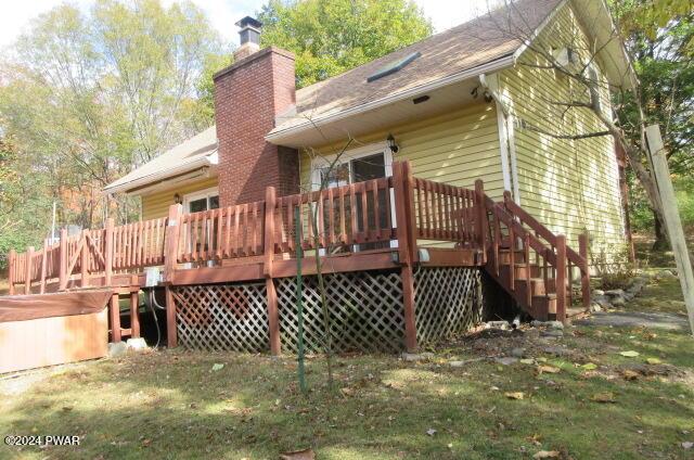 back of property featuring a wooden deck