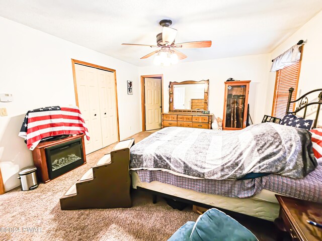 bedroom with carpet flooring, ceiling fan, and a closet