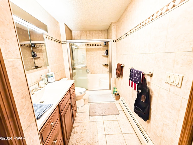 bathroom featuring baseboard heating, a textured ceiling, toilet, a shower with door, and tile walls