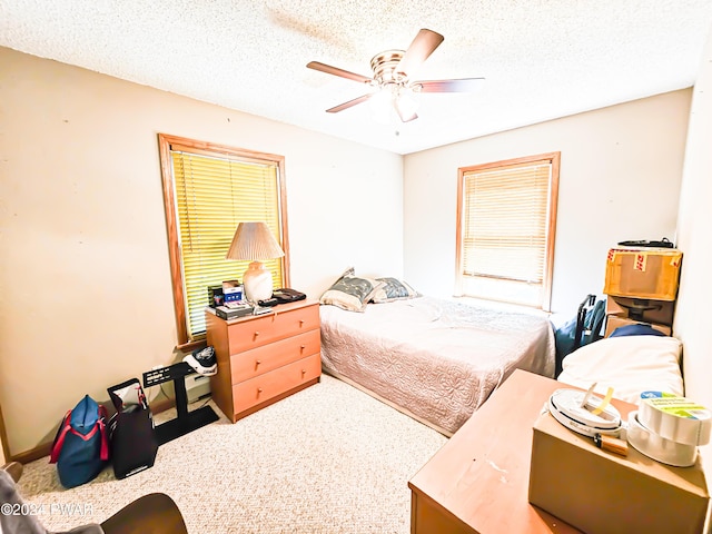 bedroom featuring ceiling fan and a textured ceiling