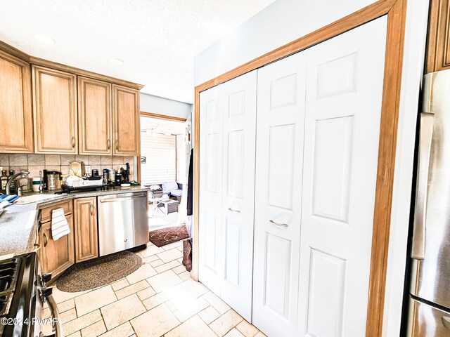 kitchen featuring decorative backsplash, sink, and stainless steel appliances