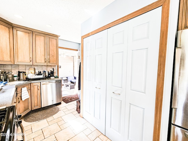 kitchen featuring decorative backsplash, sink, and stainless steel appliances