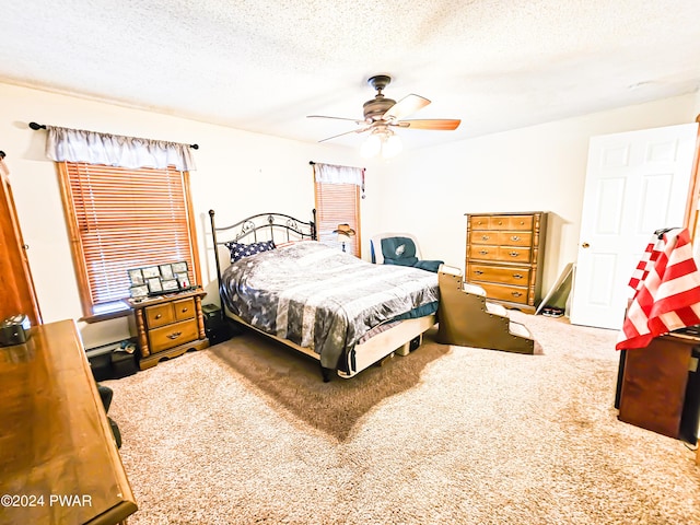 carpeted bedroom featuring a textured ceiling and ceiling fan