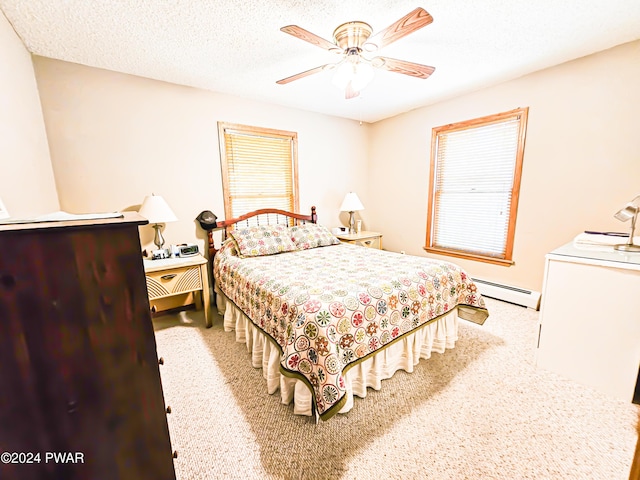 bedroom featuring a textured ceiling, a baseboard radiator, and ceiling fan