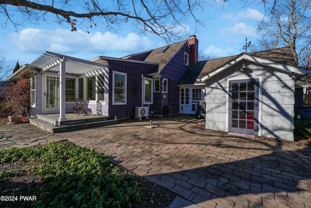 back of property with a pergola, ac unit, and a patio