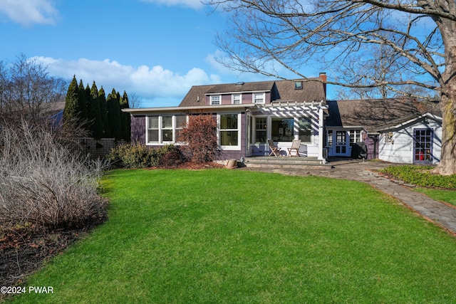 rear view of house with a pergola and a yard