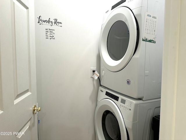 clothes washing area with laundry area and stacked washing maching and dryer