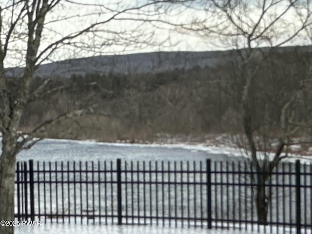 snow covered gate featuring fence