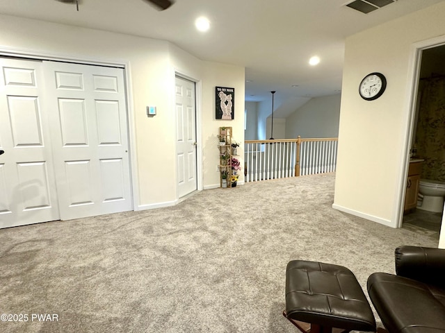 living area featuring carpet floors, recessed lighting, visible vents, and baseboards