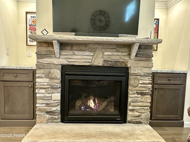 room details featuring a fireplace and wood finished floors