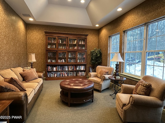 sitting room featuring recessed lighting, carpet flooring, visible vents, a tray ceiling, and wallpapered walls