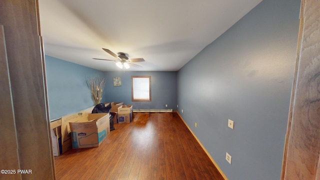 miscellaneous room with hardwood / wood-style floors, ceiling fan, and a baseboard heating unit