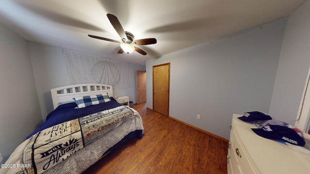 bedroom with dark hardwood / wood-style floors and ceiling fan