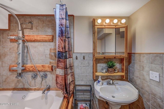 1007 Apache Ct, Lake Ariel, PA 18436 - full bath featuring tile walls, a sink, shower / tub combo with curtain, and wainscoting