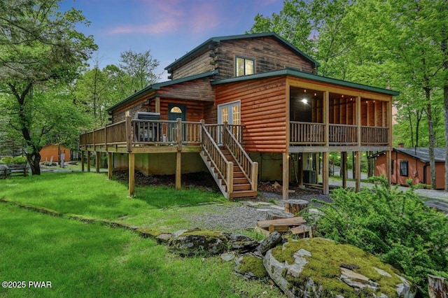 1007 Apache Ct, Lake Ariel, PA 18436 - back of house at dusk featuring stairway, central air condition unit, a deck, a yard, and log siding