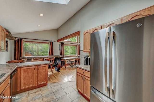 1007 Apache Ct, Lake Ariel, PA 18436 - kitchen with stainless steel appliances, vaulted ceiling, light tile patterned flooring, recessed lighting, and tasteful backsplash
