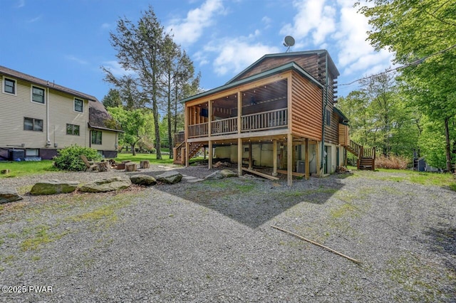 1007 Apache Ct, Lake Ariel, PA 18436 - back of house with stairway, a sunroom, a wooden deck, and cooling unit