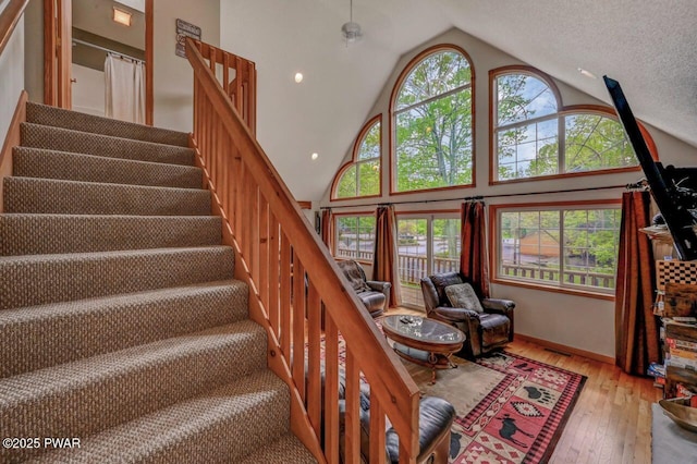 1007 Apache Ct, Lake Ariel, PA 18436 - stairway with hardwood / wood-style floors, high vaulted ceiling, and baseboards