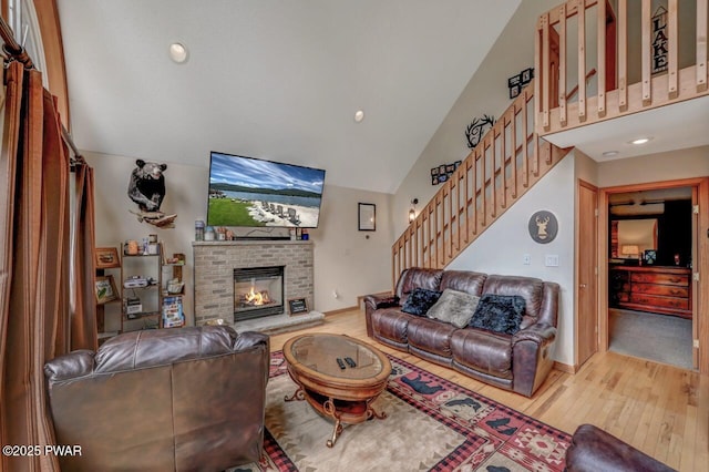 1007 Apache Ct, Lake Ariel, PA 18436 - living area with wood finished floors, stairway, lofted ceiling, a brick fireplace, and recessed lighting