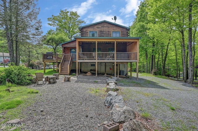 1007 Apache Ct, Lake Ariel, PA 18436 - rear view of property with log siding, a wooden deck, and stairway
