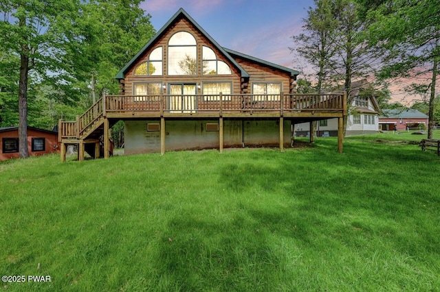 1007 Apache Ct, Lake Ariel, PA 18436 - back of property at dusk with log exterior, a wooden deck, and a lawn